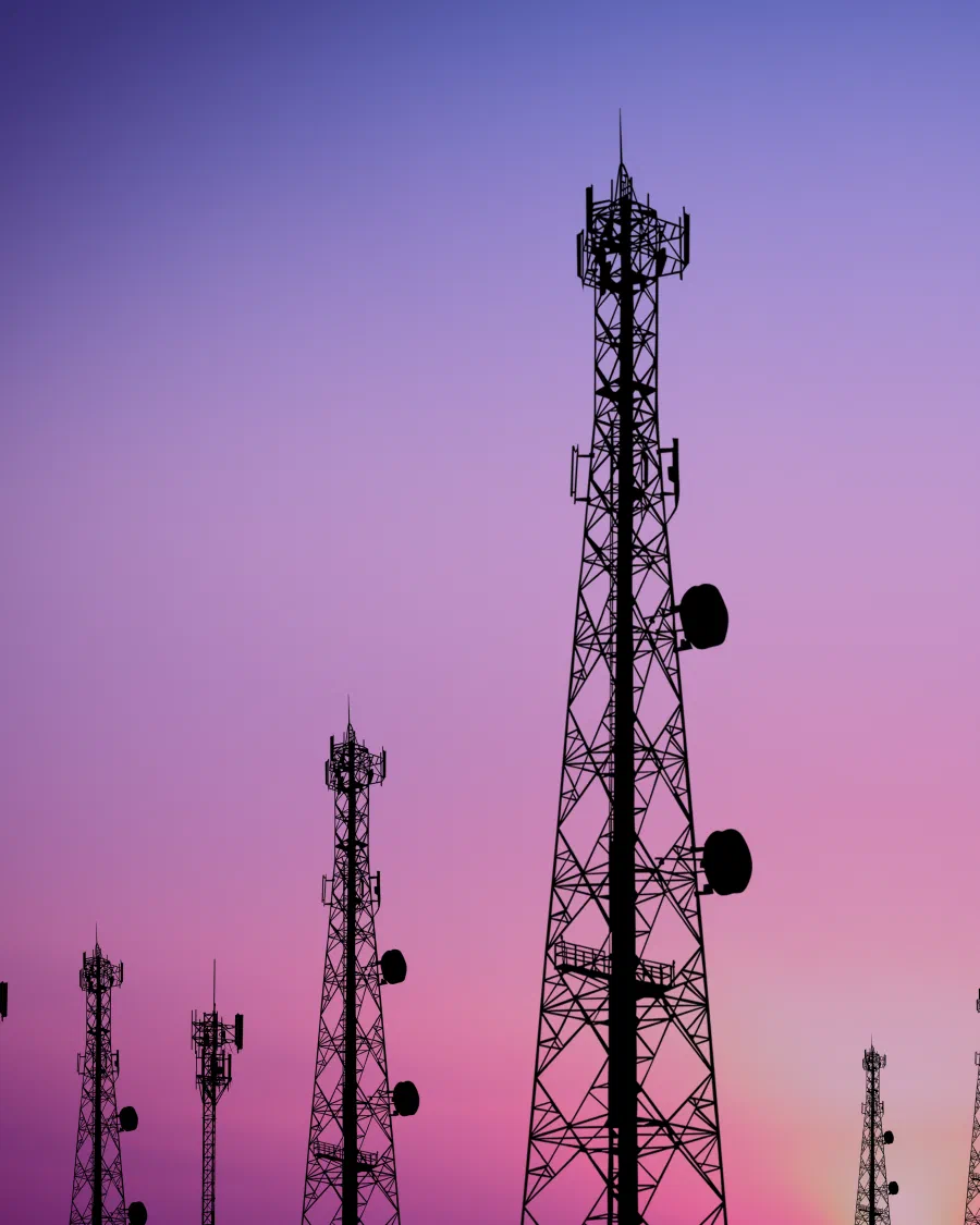 Nimbus LTE towers silhouetted against a Colorado twilight sky